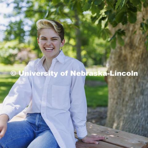 Ally Barry, a junior in environmental studies, sits in the arboretum on East Campus, one of her favorite places on campus.  Photo for her PRIDE month feature story. June 3, 2022. Photo by Craig Chandler / University Communication. 