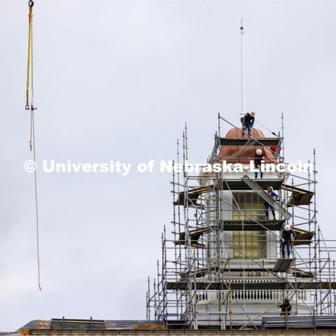 Walkway pieces are relayed into place as scaffolding work begins to surround the Love Library cupola as part of the renovation process. June 6, 2022. Photo by Craig Chandler / University Communication.