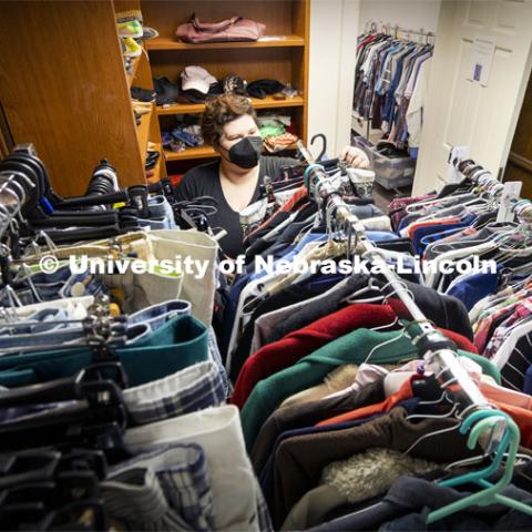 JD McCown, Assistant Director of the LGBTQA+ Center, arranges donated clothing the in the Lavender Closet. June 6, 2022. Photo by Craig Chandler / University Communication.