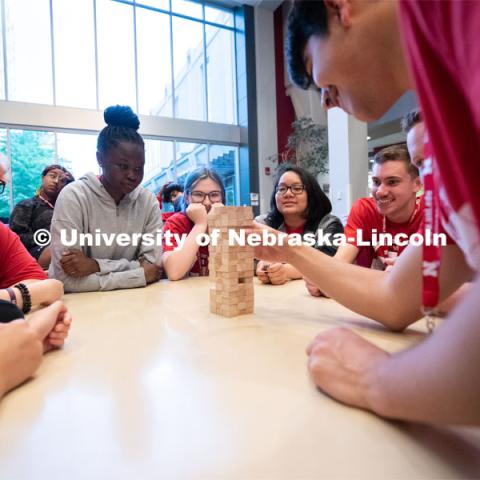 Attendees take turns removing blocks during a game of Jenga at the Nebraska College Preparatory Academy’s Science Camp inside Abel Hall. NCPA, a program for academically talented, first-generation, income eligible students to help prepare them for college and their future careers. June 9, 2022. Photo by Jordan Opp for University Communication.