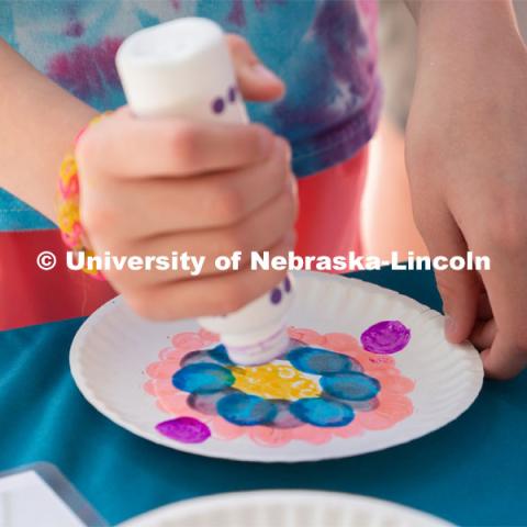 Discovery Day attendees create flower patterns on a plate using an array of colors. The East Campus Discovery Days and Farmer’s Market at UNL is a fun, family-friendly event for all ages. It’s more than a farmer’s market. It’s more than a science day. Come for the hands-on, science-focused fun. Stay to enjoy live music and food trucks. Shop at our farmer’s market and vendor fair. June 11, 2022. Photo by Jordan Opp / University Communication.