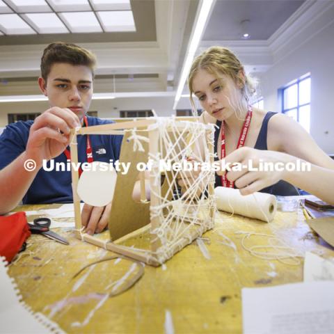 High school students in the College of Architecture high school camp work on their projects with Aziza Cyamani, Assistant Professor of Architecture. June 16, 2022. Photo by Craig Chandler / University Communication.