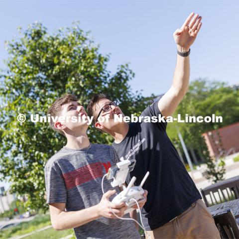 Journalism professor Matt Waite, coaches Xander Munson of Nebraska City as Munson flies a drone outside of Andersen Hall.  Munson and other high school students are on camps for the 4-H Digital Media Big Red Academic Camp. June 16, 2022. Photo by Craig Chandler / University Communication.