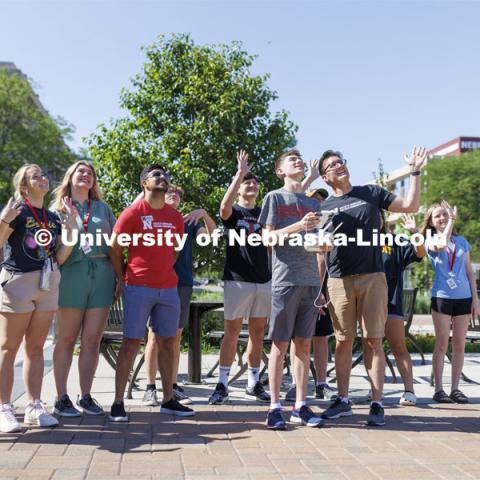 Journalism professor Matt Waite and the 4-H Digital Media Big Red Academic Camp wave to the camera on a drone being flown by Xander Munson of Nebraska City.  June 16, 2022. Photo by Craig Chandler / University Communication.