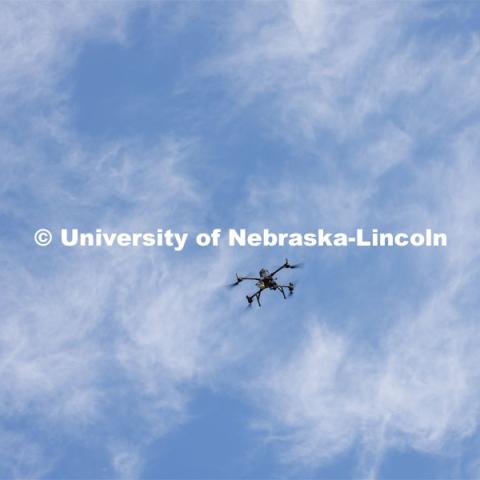 An autonomous drone photographs a field of triticale at the research fields at 84th and Havelock. Biological Systems Engineering fieldwork with drones for phenotyping fields. June 27, 2022. Photo by Craig Chandler / University Communication.