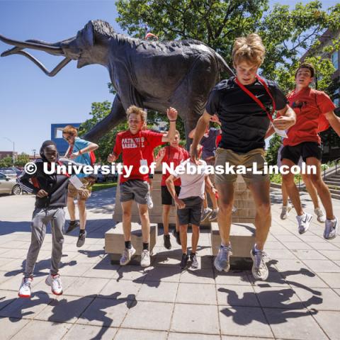 Students leap for joy in front of Archie. New student enrollment orientation and campus tours. June 28, 2022. Photo by Craig Chandler / University Communication.