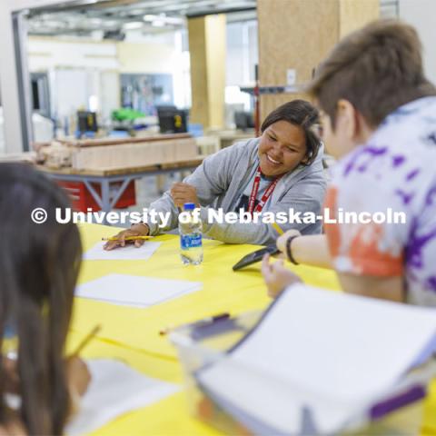 Alana Denney laughs while looking at images for her design with academy mentor Shiloh King. 2022 MATC/NCIA Sovereign Native Youth STEM Leadership Academy. June 30, 2022. Photo by Craig Chandler / University Communication.