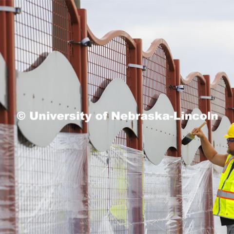 Dirk Edwards edges the wave-patterned artwork on the overpass. Building Systems Maintenance paints the artwork on the overpasses of North Antelope Valley Parkway and Salt Creek Roadway. July 7, 2022. Photo by Craig Chandler / University Communication.