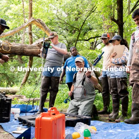 Research Engineer Alan Boldt (center-right) assembles tools to measure the water flow rates of Salt Creek at Wilderness Park. Irrigation Laboratory and Field Course class trip to Salt Creek at Wilderness Park. July 8, 2022. Photo by Jordan Opp for University Communication.