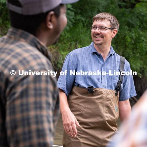 Professor Derek Heeren laughs with students during his Irrigation Laboratory and Field Course class trip to Salt Creek at Wilderness Park. July 8, 2022. Photo by Jordan Opp for University Communication.