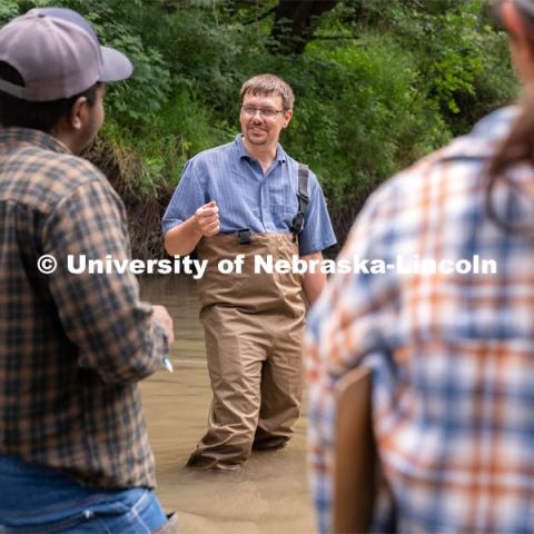 Professor Derek Heeren speaks with students during his Irrigation Laboratory and Field Course class trip to Salt Creek at Wilderness Park. July 8, 2022. Photo by Jordan Opp for University Communication.