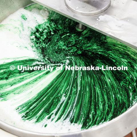 Food coloring and flavor swirl together in the mixing vat. Dairy Store 4-H Clover Mint is being made at Food Innovation Center on Nebraska Innovation Campus. July 18, 2022. Photo by Craig Chandler / University Communication.