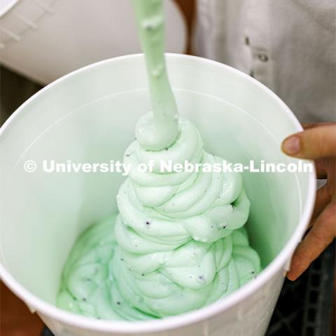 Dairy Store 4-H Clover Mint is extruded into 3-gallon buckets after it comes out of the machine which turns the mix into soft serve Ice cream at Food Innovation Center on Nebraska Innovation Campus. July 18, 2022. Photo by Craig Chandler / University Communication.