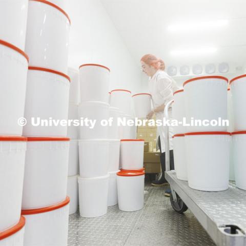 April Johnson is surrounded by fog as she stacks the Dairy Store 4-H Clover Mint into the flash freezer at the Food Innovation Center on Nebraska Innovation Campus. July 18, 2022. Photo by Craig Chandler / University Communication.