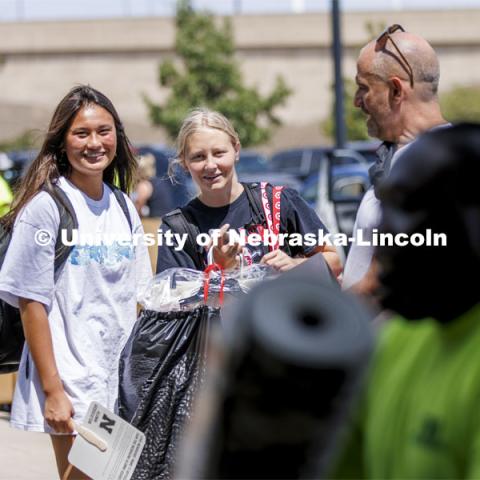 Lily Tobin, left, and Stella Minge, both of Omaha, watch their possessions head for their Schramm Hall room. Residence Hall move in for students participating in Greek Rush. August 14, 2022. Photo by Craig Chandler / University Communication.