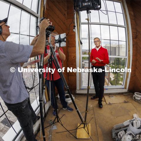 Dave Fitzgibbon and Curtis Bright of UCOMM film the Chancellor as he welcomes students back in his welcome back video. Chancellor Ronnie Green and his wife, Jane, climbed the ladder in the cupola on Love Library to film his welcome back videos to the students and campus. August 16, 2022. Photo by Craig Chandler / University Communication.