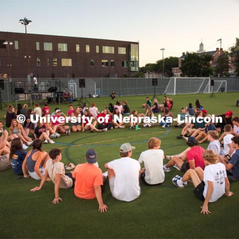 Students sit in a circle during the Playfair activity at the Vine Street Fields Wednesday night as part of Big Red Welcome. August 17, 2022. Photo by Gus Kathol for University Communication.