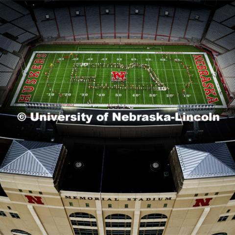 The band forms an outline of the state of Nebraska. Cornhusker Marching Band practice in Memorial Stadium under the lights. August 18, 2022. Photo by Craig Chandler / University Communication.