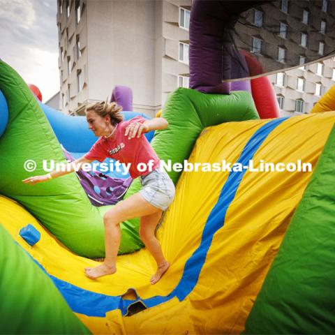Students tumble through the inflatable obstacle course at Harper Schramm Smith residence halls block party. August 18, 2022. Photo by Craig Chandler / University Communication.