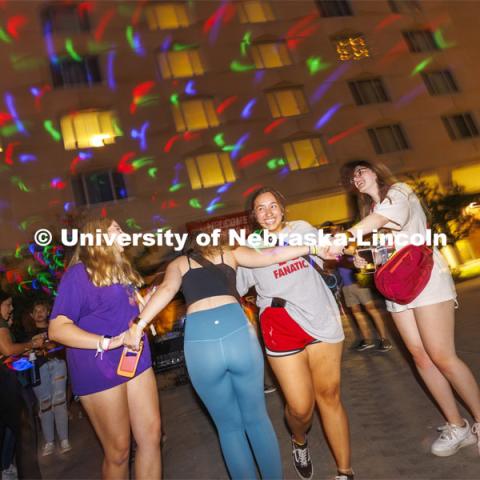 Alyssa Garcia-Sybert, a freshman from Omaha, smiles as she dances with friends at the Harper Schramm Smith residence halls block party. August 18, 2022. Photo by Craig Chandler / University Communication.