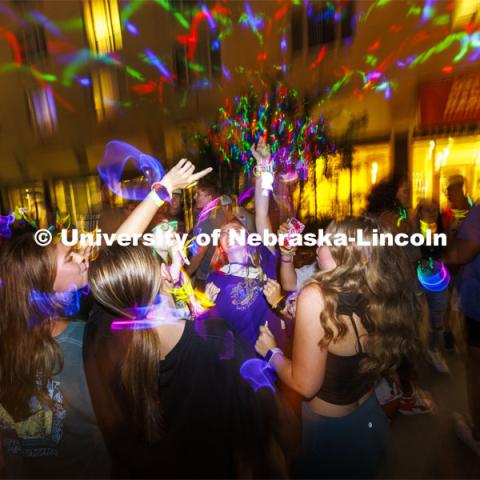 Lydia Hernandez, a freshman from Omaha, smiles as she dances with her friends at the Harper Schramm Smith residence halls block party. August 18, 2022. Photo by Craig Chandler / University Communication.