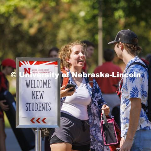Lara Celesky talks with Brock Godown as the Cornhusker Marching Band Members grab a bite to eat the Hixon-Lied College Welcome for new and returning students. Big Red Welcome - College Welcome Programs. August 18, 2022. Photo by Craig Chandler / University Communication.