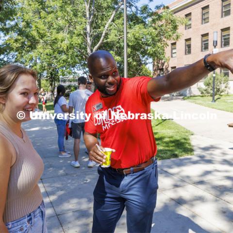 Nicolas Gordan, a College of Arts and Sciences recruiter helps a student at the CAS College Welcome for new and returning students. Big Red Welcome - College Welcome Programs. August 18, 2022. Photo by Craig Chandler / University Communication.