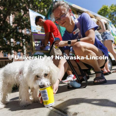 8-month-old Bailey eats his own Kona Ice along with his owner Zoie Malesker, a junior from Omaha, at the College of Arts and Sciences event for new and returning students. Big Red Welcome - College Welcome Programs. August 18, 2022. Photo by Craig Chandler / University Communication.