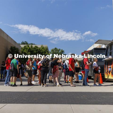 Students line up for the food trucks sponsored by the Hixon-Lied College of Fine and Performing Arts for their College Welcome for new and returning students. Big Red Welcome - College Welcome Programs. August 18, 2022. Photo by Craig Chandler / University Communication.
