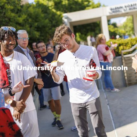 Adian Upton, a freshman from Omaha, talks over the food choices with friends at the Hixon-Lied College of Fine and Performing Arts for their College Welcome for new and returning students. Big Red Welcome - College Welcome Programs. August 18, 2022. Photo by Craig Chandler / University Communication.