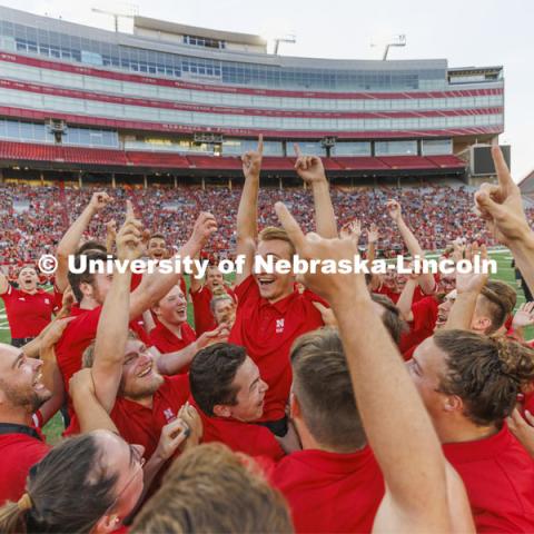 Drew Carlson, a freshman trumpet player from North Platte, is hoisted in the arms of the trumpet section after winning the drill down competition. Big Red Welcome week featured the Cornhusker Marching Band Exhibition in Memorial Stadium where they showed highlights of what the band has been working on during their pre-season Band Camp, including their famous “drill down”. August 19, 2022.  Photo by Craig Chandler / University Communication.