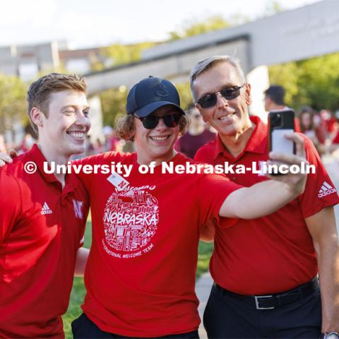 Jacob Drake, ASUN President, left, and Chancellor Ronnie Green, right, pose for a selfie with Sam Pribyl. Chancellor’s BBQ to welcome the class of 2026 in the greenspace by the Nebraska Union. August 19, 2022. Photo by Craig Chandler / University Communication.