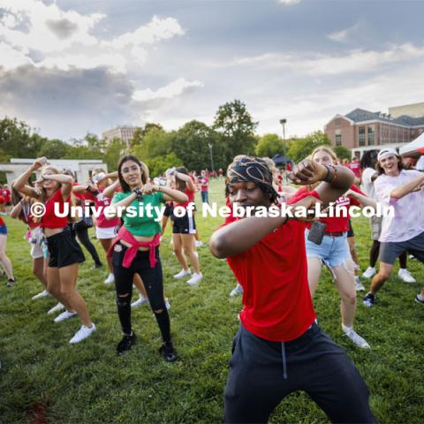Dismas Nsabiyumva from Omaha leads a group dance at the Chancellor’s BBQ to welcome the class of 2026 in the greenspace by the Nebraska Union. August 19, 2022. Photo by Craig Chandler / University Communication.