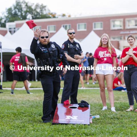 UNL Police Department officers play cornhole at the Chancellor’s BBQ to welcome the class of 2026 in the greenspace by the Nebraska Union. August 19, 2022. Photo by Craig Chandler / University Communication.