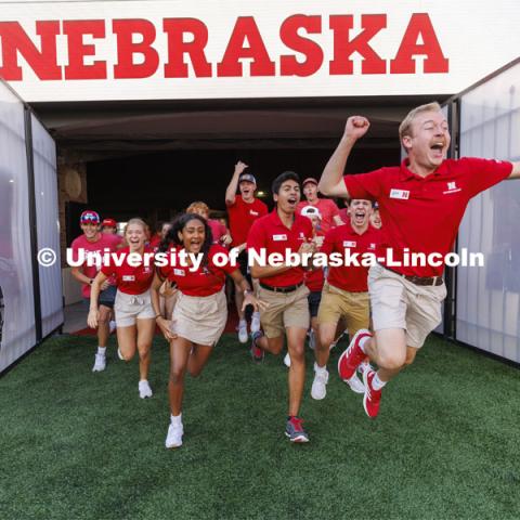 NSE Orientation Leader Jackson Anderson leads the new students out of the Tunnel Gates at the Tunnel Walk and New Student Welcome in Memorial Stadium. August 19, 2022. Photo by Craig Chandler / University Communication.