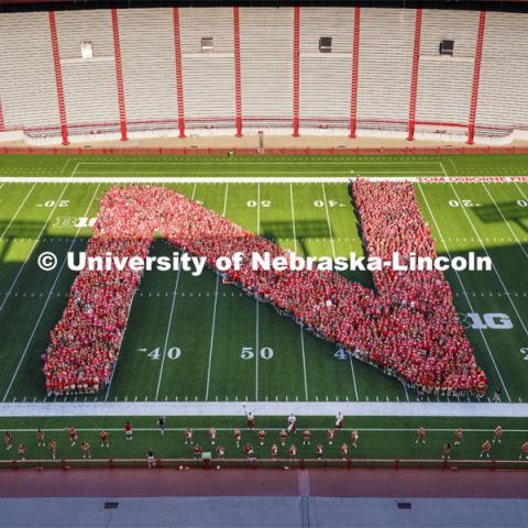 Freshman students form the N on the Memorial Stadium field for the class of 2026 photo. Tunnel Walk and New Student Welcome in Memorial Stadium. August 19, 2022. Photo by Jordan Opp for University Communication.