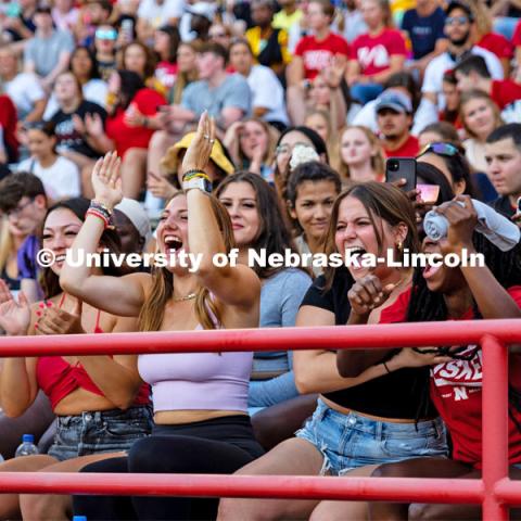 UNL students cheering as they catch a t-shirt at the Boneyard Bash in Memorial Stadium. August 20, 2022. Photo by Kirk Rangel for University Communication.
