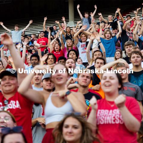 UNL students cheering and getting on their feet at the Boneyard Bash in Memorial Stadium. August 20, 2022. Photo by Kirk Rangel for University Communication.