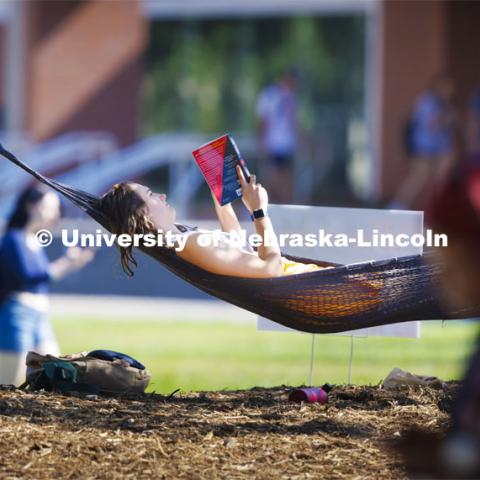 Kaylee Davis of Gretna relaxes with a book in the hammocks outside the Nebraska Union. First day of classes. August 22, 2022. Photo by Craig Chandler / University Communication.