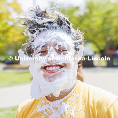 Quinton Chavez smiles after taking a pie to the face as he and Acacia Fraternity brothers raise money for Bryan Health. Acacia fraternity held a pie-in-the-face fundraiser for Bryan Health’s new cancer center. All the UNL fraternities are participating and have raised more than $200,000 so far this year. August 25, 2022. Photo by Craig Chandler / University Communication.