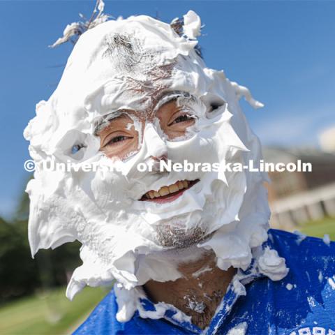 Jarrett Michie smiles after taking a pie to the face as he and Acacia Fraternity brothers raise money for Bryan Health. Acacia fraternity held a pie-in-the-face fundraiser for Bryan Health’s new cancer center. All the UNL fraternities are participating and have raised more than $200,000 so far this year. August 25, 2022. Photo by Craig Chandler / University Communication.