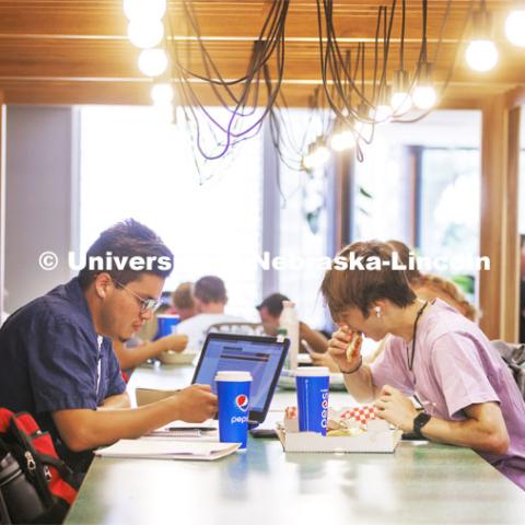 Chase Tabor, right, a sophomore from Pyeongtaek, South Korea, eats a gluten-free pizza as he and Marcus Vazquez, a sophomore from Grand Island, eat and study in the newly remodeled Selleck Dining Hall. The area has been turned into a food court with new seating areas. August 30, 2022. Photo by Craig Chandler / University Communication.