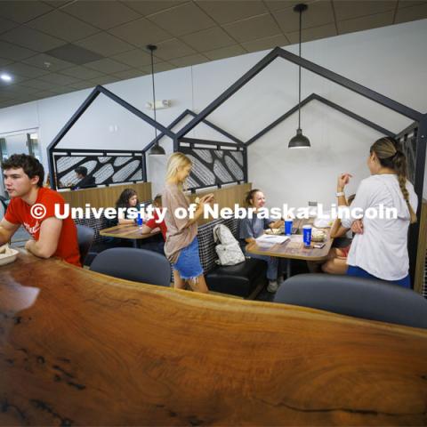 Livi Swanson, a freshman from Lincoln, talks with friends as she eats in one of the new seating areas in Selleck Dining Hall. The area has been turned into a food court with new seating areas. August 30, 2022. Photo by Craig Chandler / University Communication.