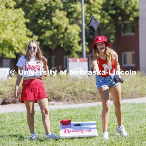 Tenley Simmons, a sophomore from Minneapolis, Minnesota, right, and Kate Aleknavicius, a sophomore from Milkwaukee, Wisconsin, compete in Corn Hole at the Student Tailgate and Unity Walk in the Union green space before the game. NU vs. North Dakota. September 3, 2022. Photo by Craig Chandler / University Communication.