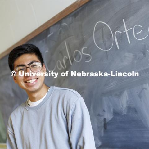 Carlos Ortega, junior in secondary education, and NSE student orientation leader, smiles for a photo in a classroom on campus. September 7, 2022.  Photo by Craig Chandler / University Communication.