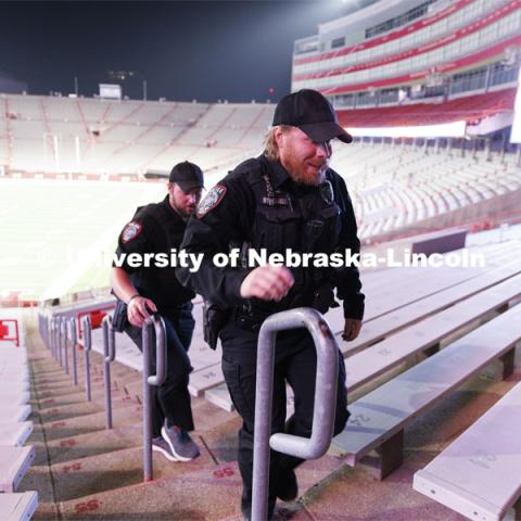 UNLPD Officer Michael Dailey, right, and UNLPD Investigator Caleb Gose walk the north stadium steps. More than 160 UNL ROTC cadets along with active-duty military personnel, local first responders and UNO Air Force ROTC cadets ran 2200 steps in Memorial Stadium today. The run honors the first responders who ran up the 110 floors of the World Trade Center on 9/11. September 8, 2022. Photo by Craig Chandler / University Communication.