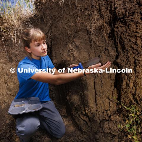 Kennadi Griffis takes a soil sample from one of the layers–called horizons in soil judging terms–in the soil judging pit on East Campus. Griffis’ curiosity about the natural environment and the opportunities she found at the University of Nebraska–Lincoln propelled the Husker to an international championship in soil judging as a member of Team USA. September 9, 2022. Photo by Craig Chandler / University Communication.