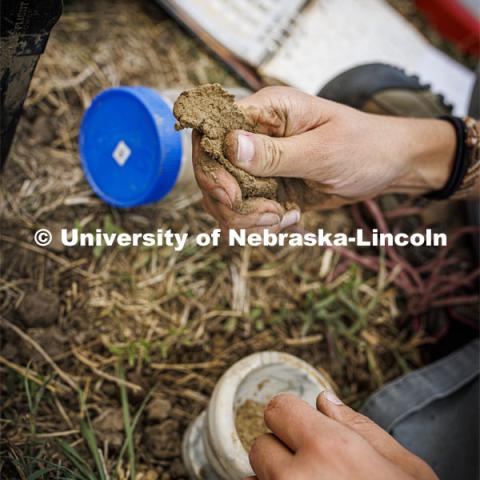 Kennadi Griffis critiques a ribbon of soil—where water is added to a ball of soil and then pressed between two fingers to form a ribbon—as part of her class assignment. Ribboning helps determine the composition of the soil. Griffis’ curiosity about the natural environment and the opportunities she found at the University of Nebraska–Lincoln propelled the Husker to an international championship in soil judging as a member of Team USA. September 9, 2022. Photo by Craig Chandler / University Communication.