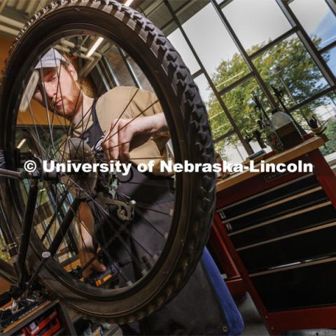 Drew Roper, a junior from Omaha, works as a bike mechanic in the shop. Outdoor Adventures Bike Shop located in the Outdoor Adventures Center on City Campus. September 15, 2022. Photo by Craig Chandler / University Communication.