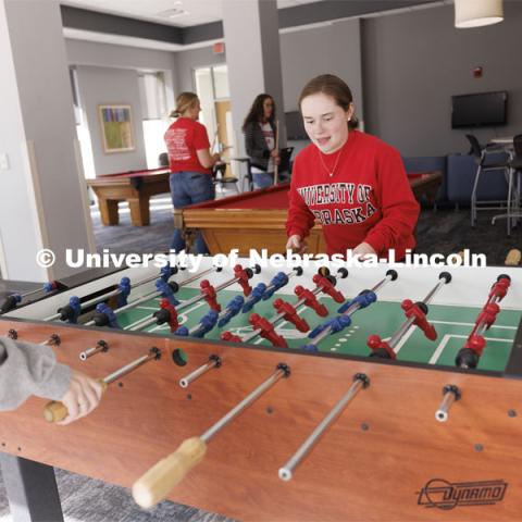 Students playing foosball. Housing Photo Shoot in Able Sandoz Residence Hall. September 27, 2022. Photo by Craig Chandler / University Communication.